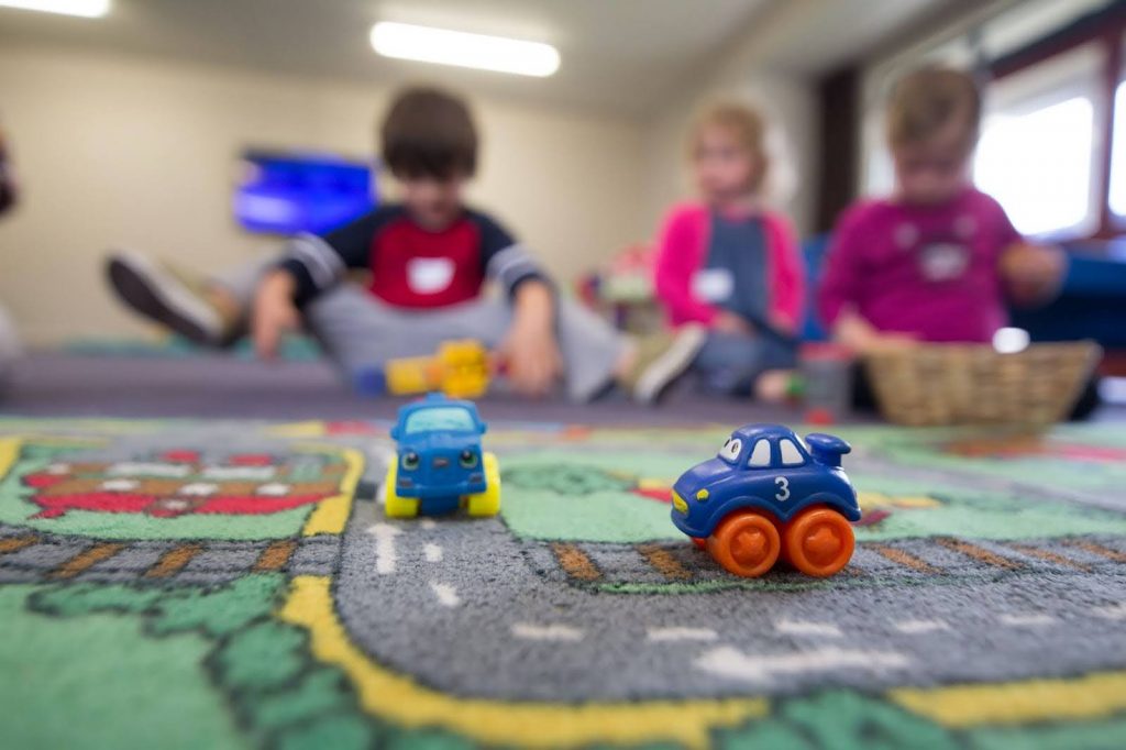 a-group-of-children-playing-with-toys-on-the-floor